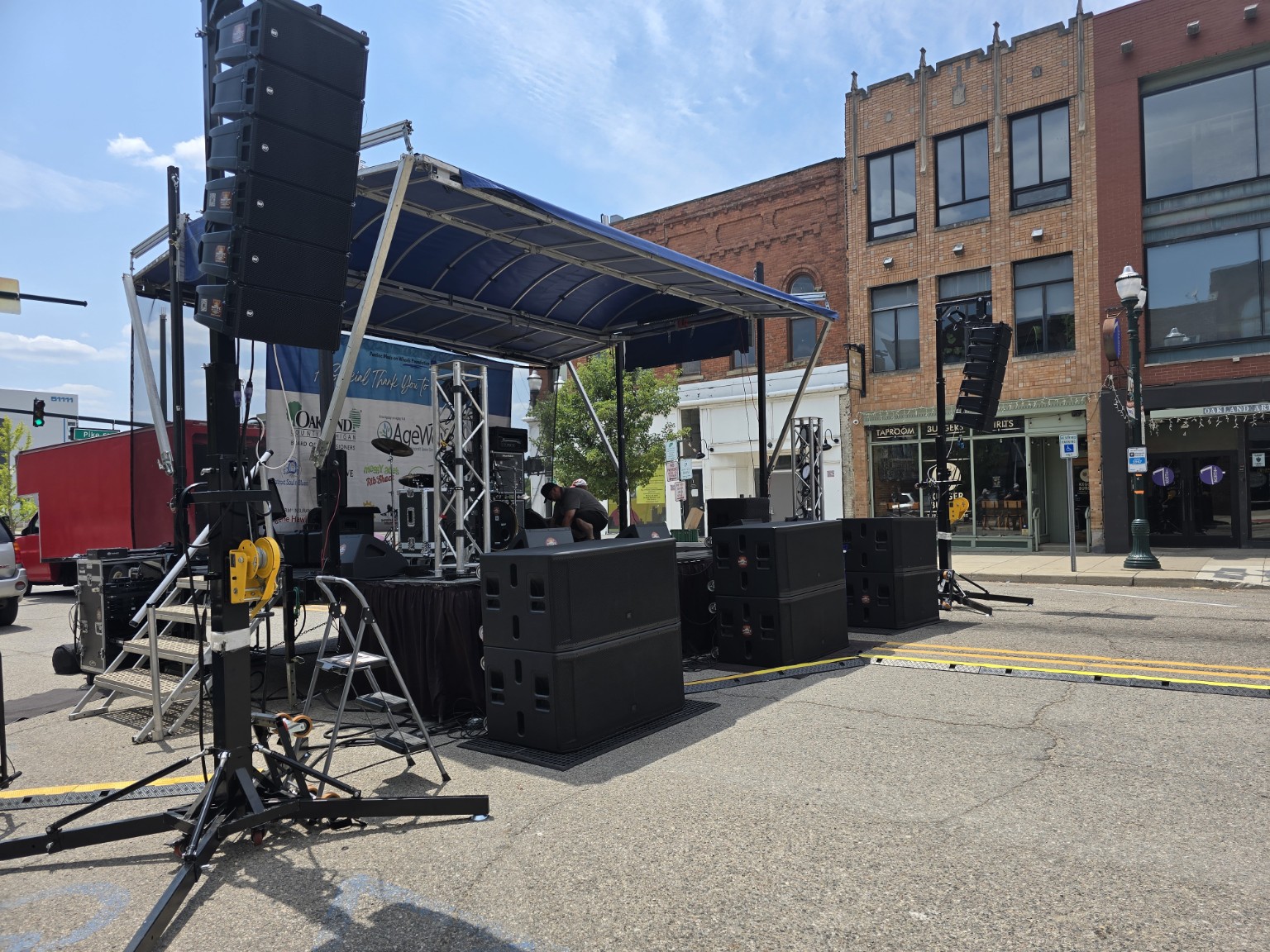 Downtown mobile stage with flown line arrays and subwoofers