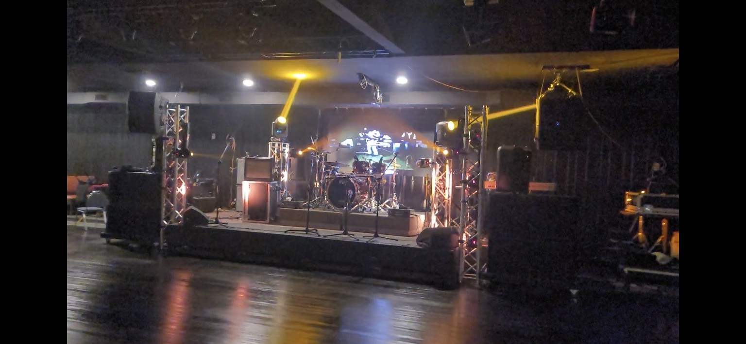 Indoor stage with coordinated yellow beam effects